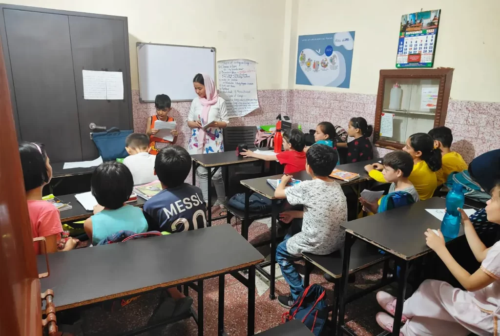 Children guided by the trainer in Refugee Services Study Centre a partner of JRDS - Development Programs at Delhi