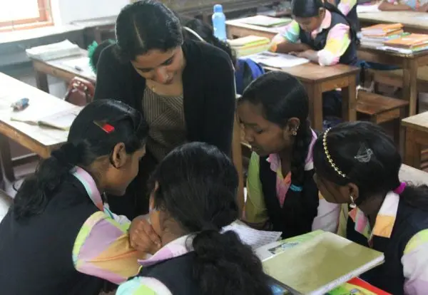 Children being mentored by their teacher at a learning and boarding facility -Arivuda- for the tribal students of Wayanad, Kerala a partner of JRDS - Development Programs